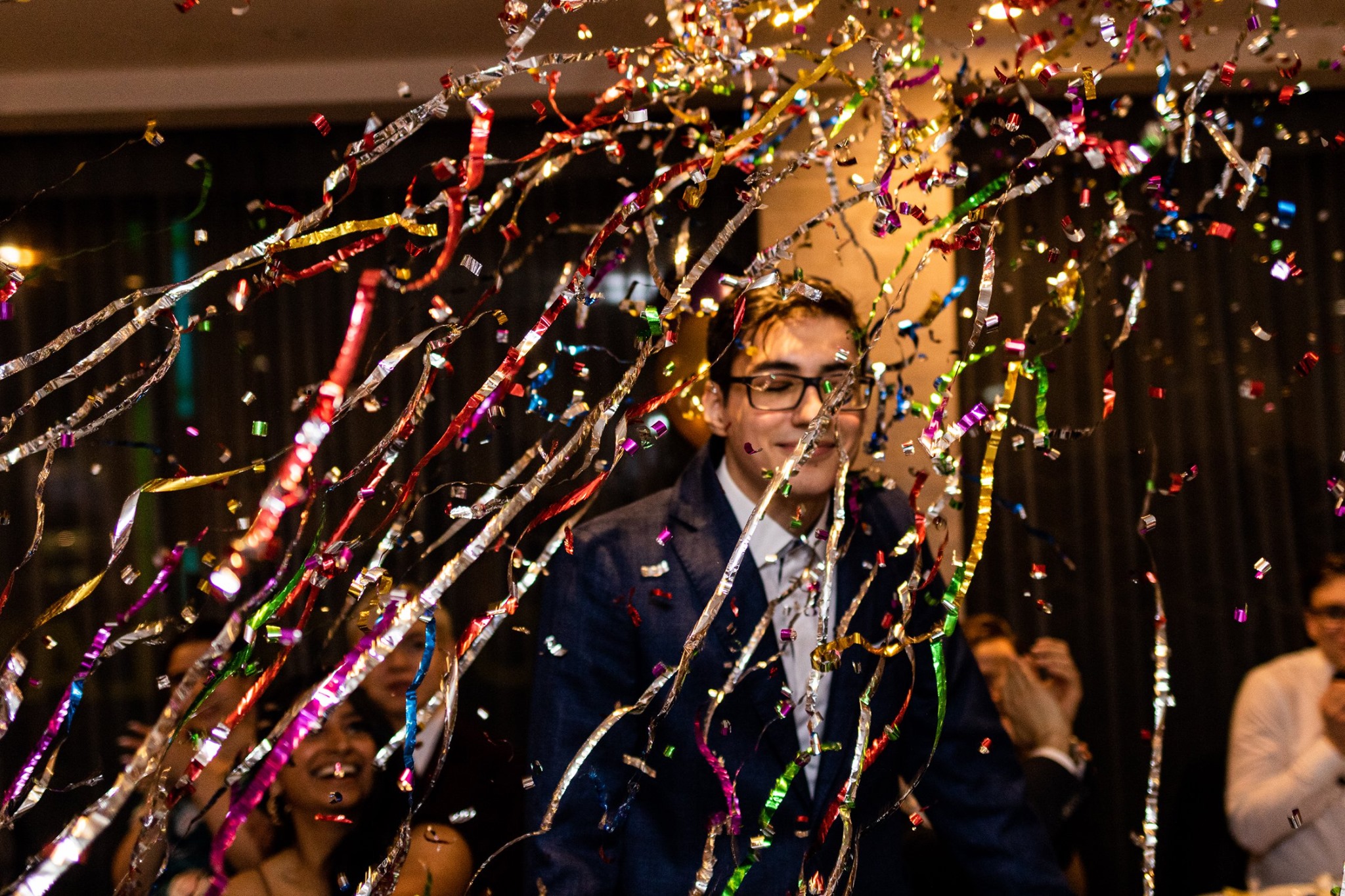 An image taken at the css ball, showing individuals out of focus behind confetti